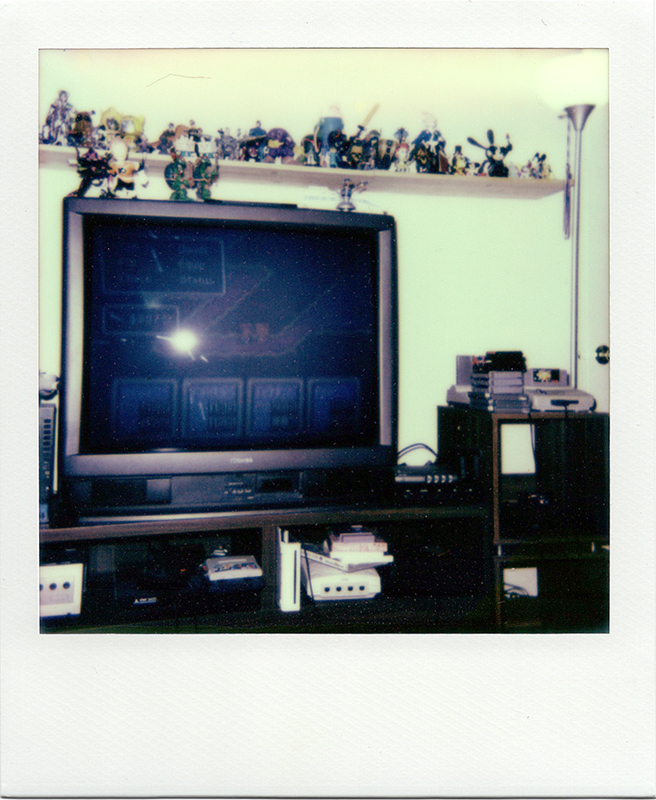 My old retro game setup, back when I lived in an apartment roughly the size of an acorn. Playing Earthbound.<br>Polaroid Spirit 600, Impossible Project film.